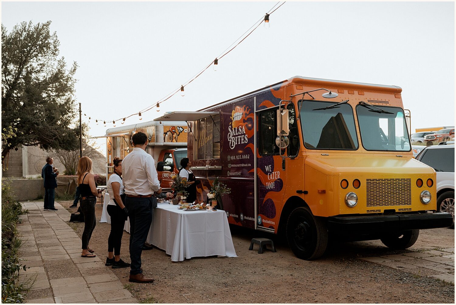 A food truck parks outside a reception hall.