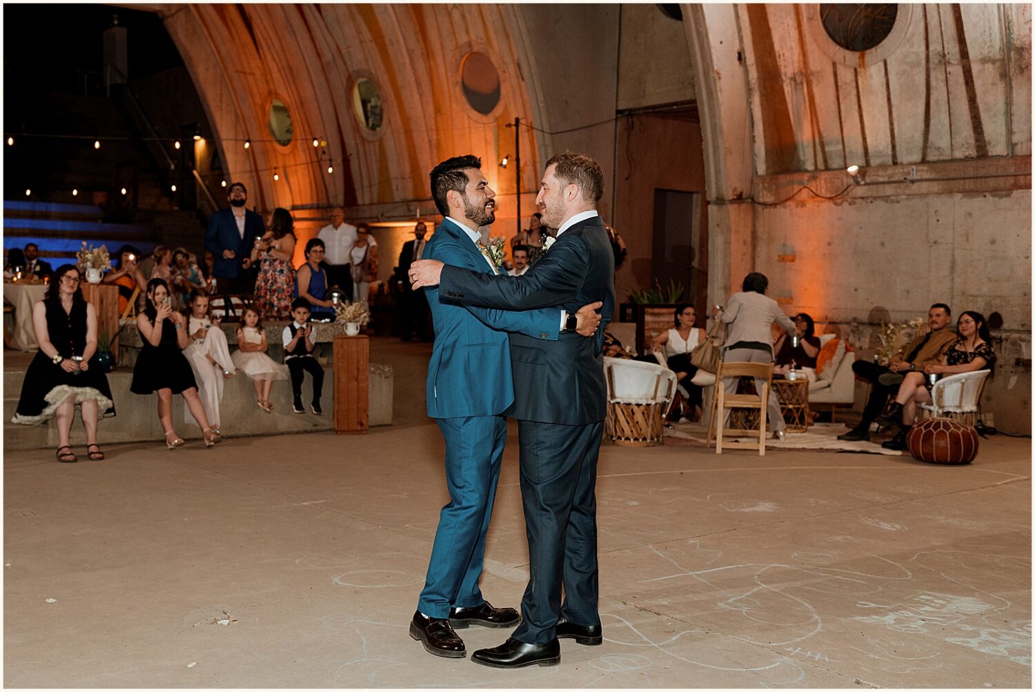 Two grooms share their first dance.