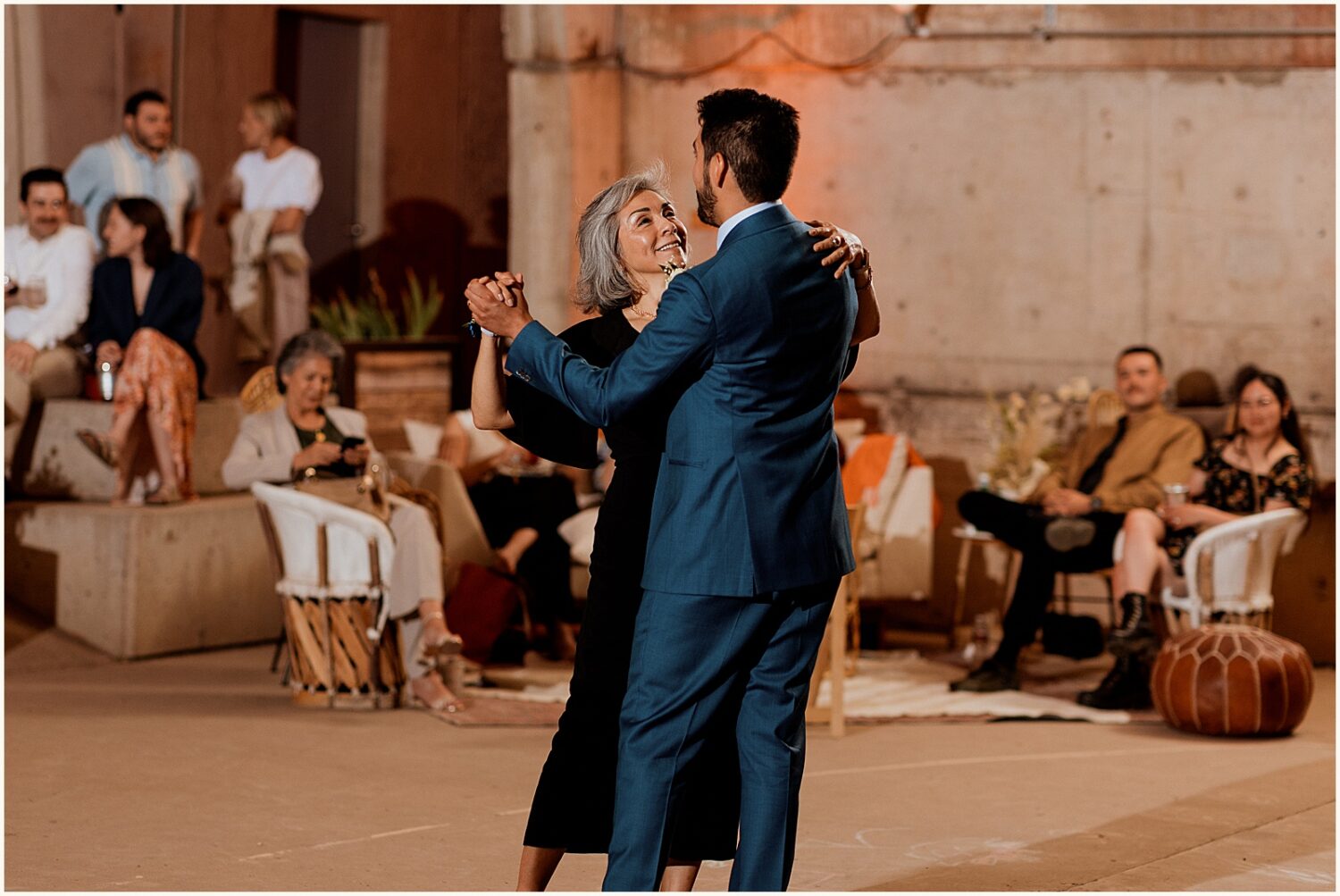 A groom dances with his mother.