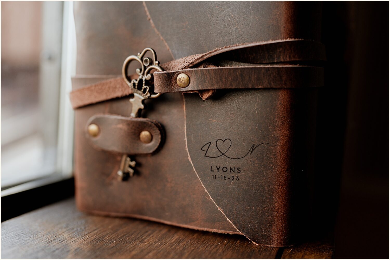An old-fashioned key hangs from a leather-bound journal.