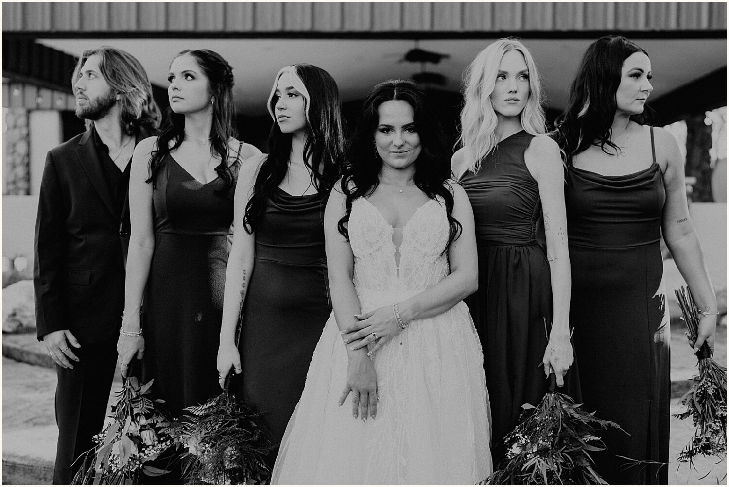 A bride poses with bridesmaids for an editorial wedding photo.