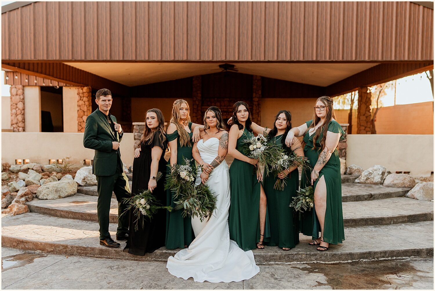 A bride poses with bridesmaids on a patio at Superstition Manor.