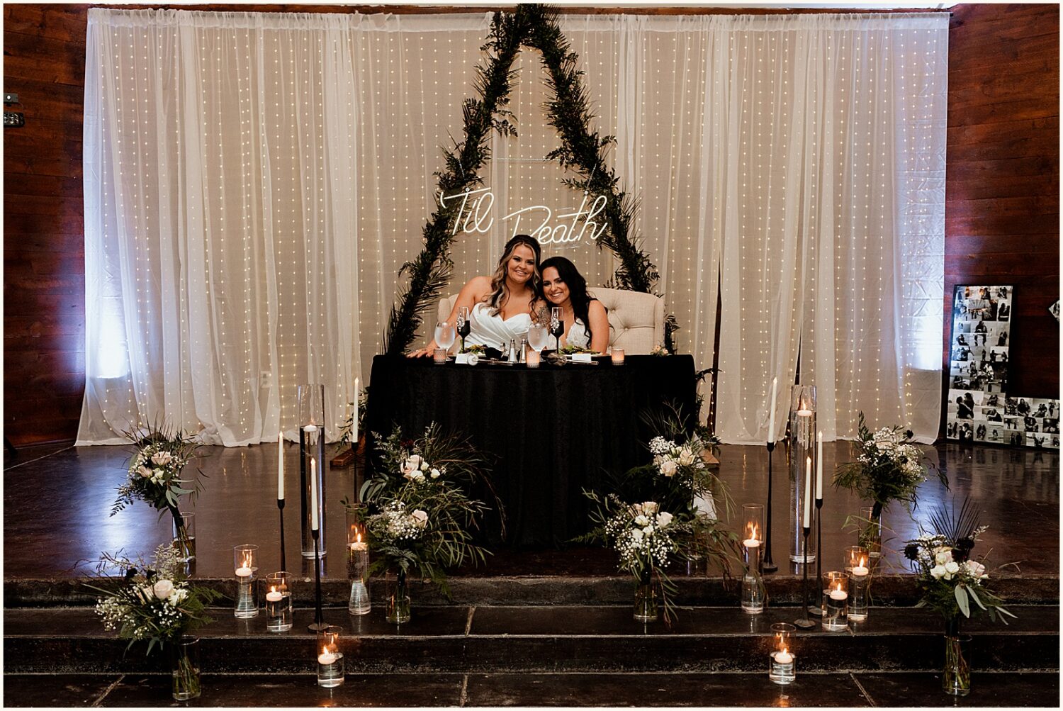 Two brides sit at a sweetheart table at a Superstition Manor wedding.