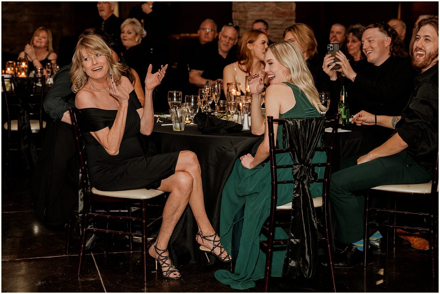 Wedding guests clap during a toast.