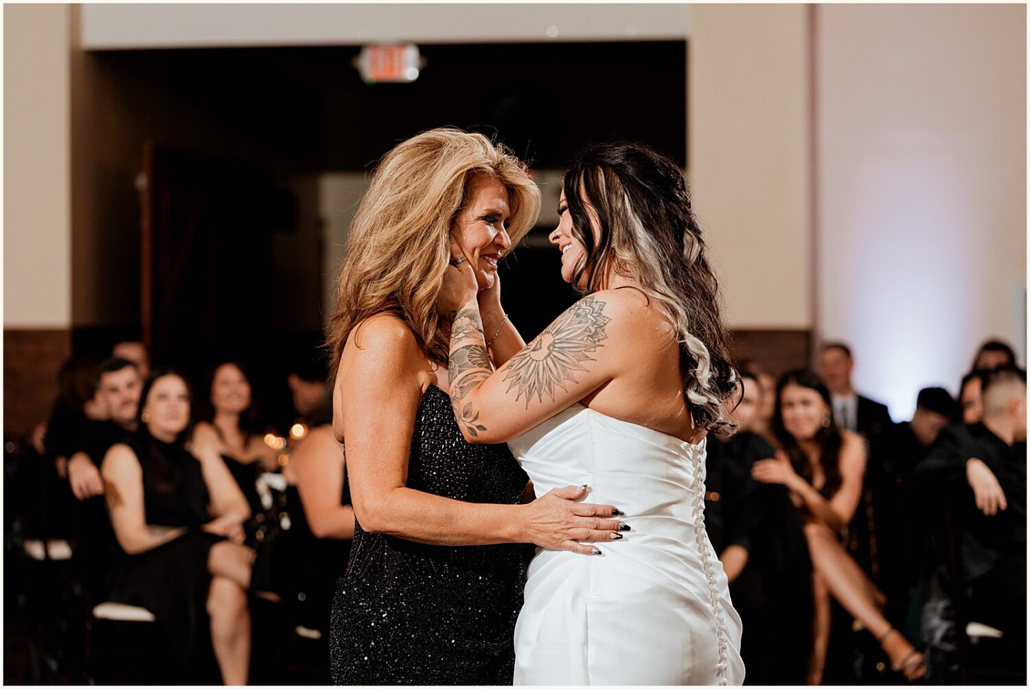 A bride dances with her mother.