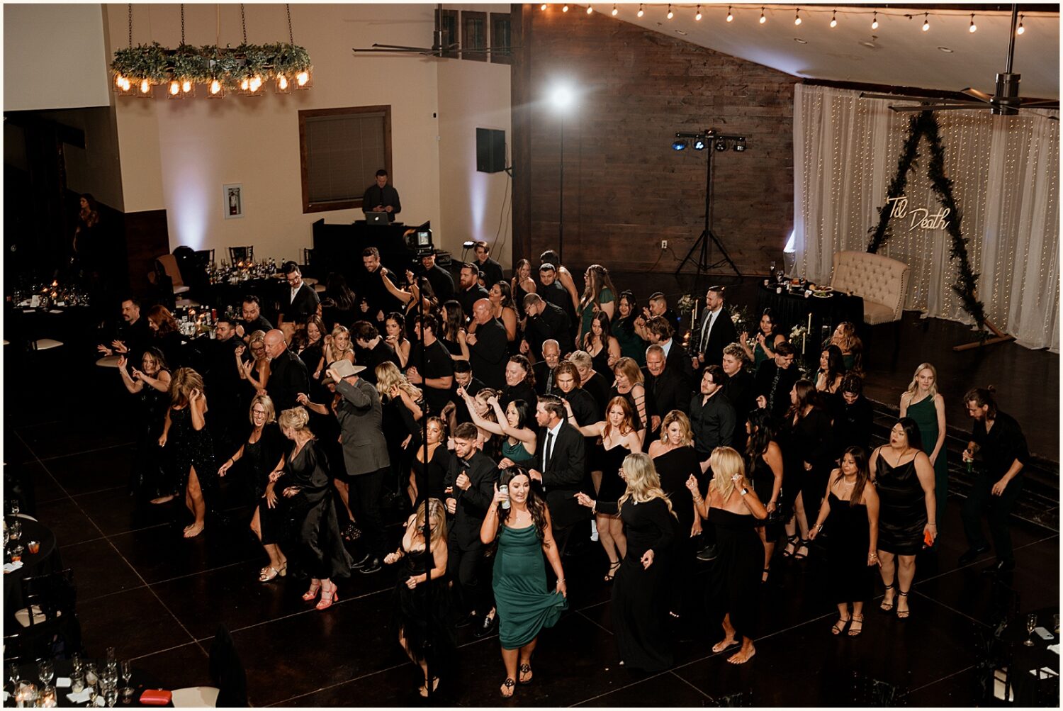Wedding guests do a line dance.